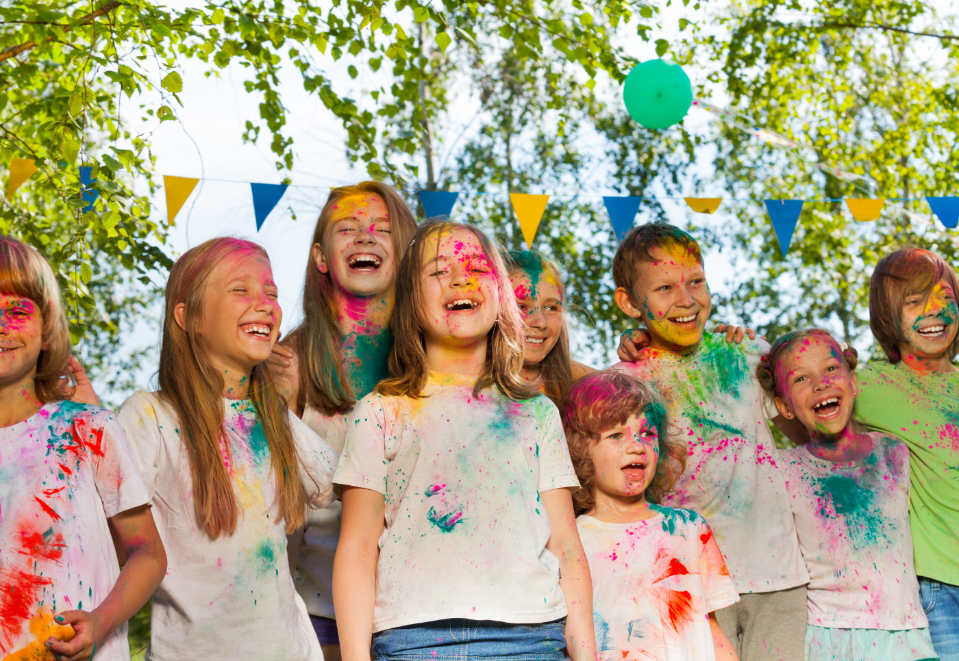 A group of kids smiling after playing with colours